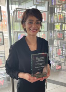 Photo of Sabrah Alajmi with award plaque